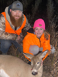 Travis with daughter deer hunting