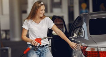 Woman filling car at gas station