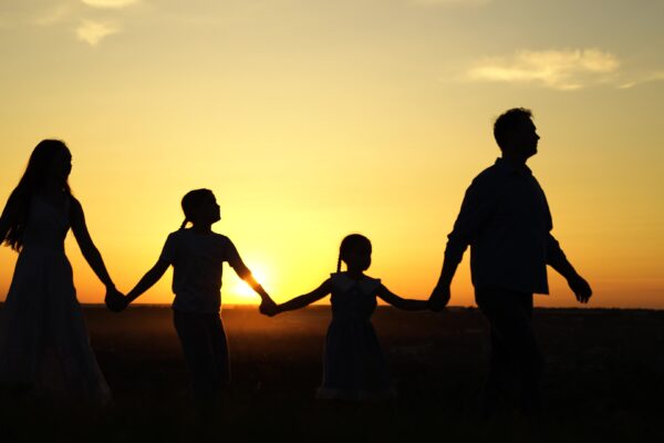 Family walking through field