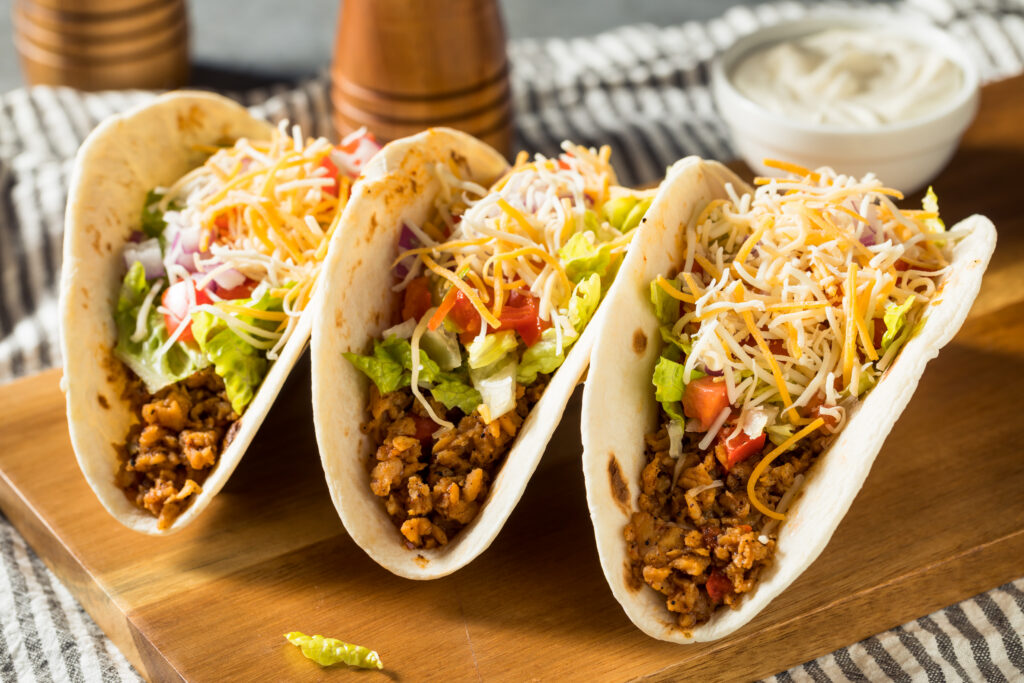 Soft shell tacos with lettuce, tomato, and cheese